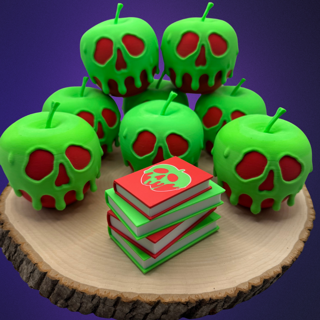 Poison apple light up stack of books with the light turned off sitting on a piece of wood surrounded by evil queen poison apples.