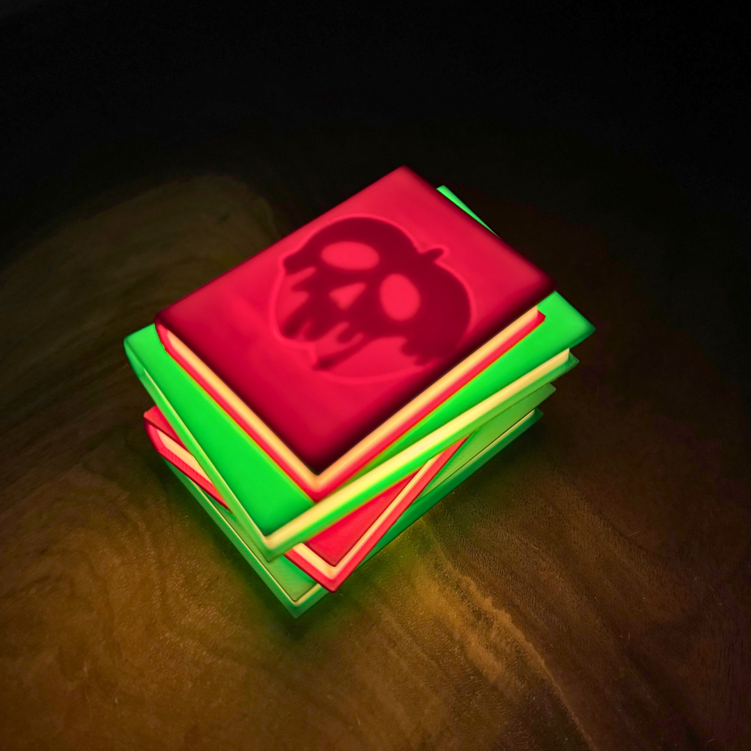 Poison apple light up stack of books sitting on a wooden shelf as book nook decor.