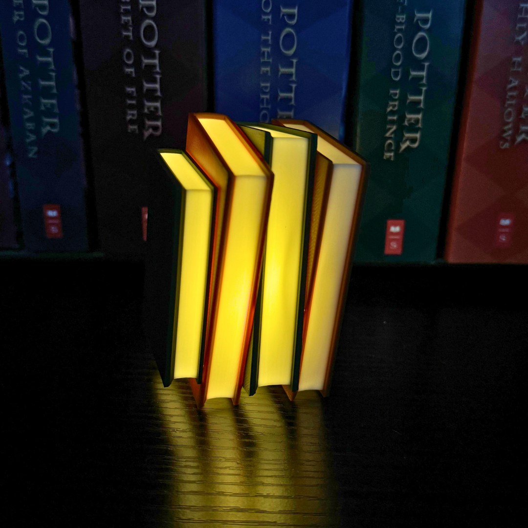 Side view of the cozy brown and green light up book stacks standing up showing the book pages with Harry Potter books in the background on the bookshelf.