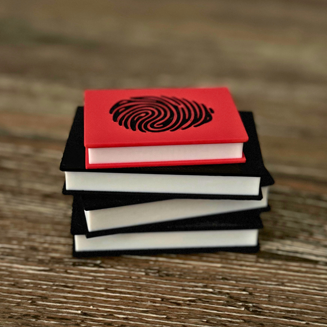 View of the True Crime Book Light with the light turned off while sitting on a wooden table.