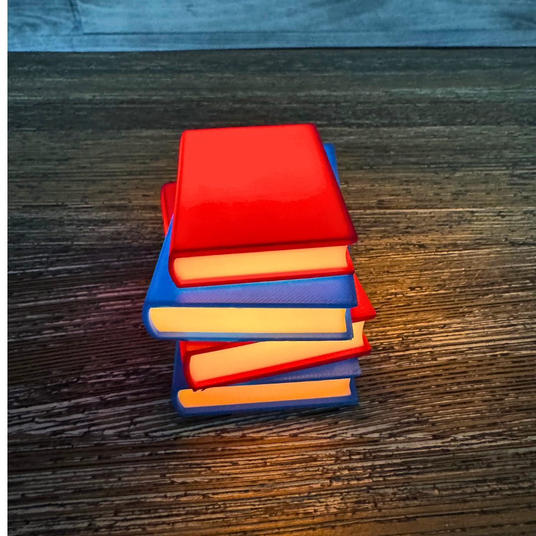 Vibrant red and blue light up stack of books sitting on a wooden shelf as bookish decor.