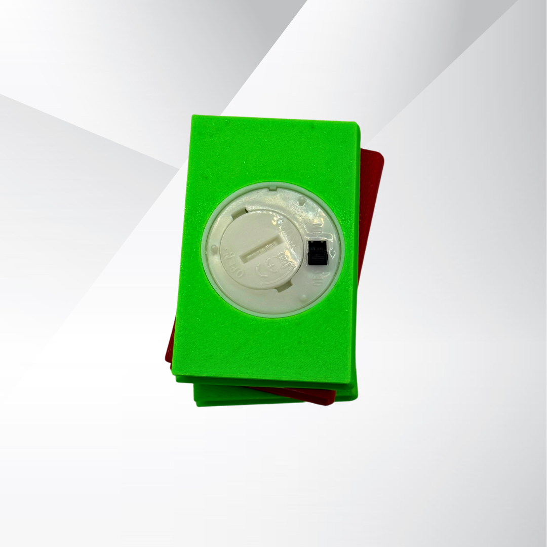 The bottom view of the poison apple light up stack of books, showing the on and off switch and where the batteries can be replaced on a white and silver background.