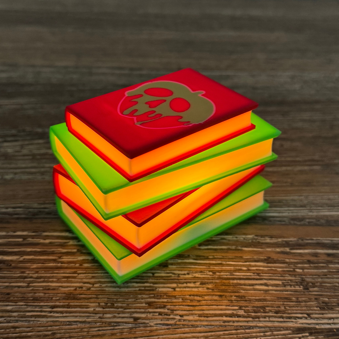 Poison apple light up stack of books sitting on a wooden shelf as bookish decor.