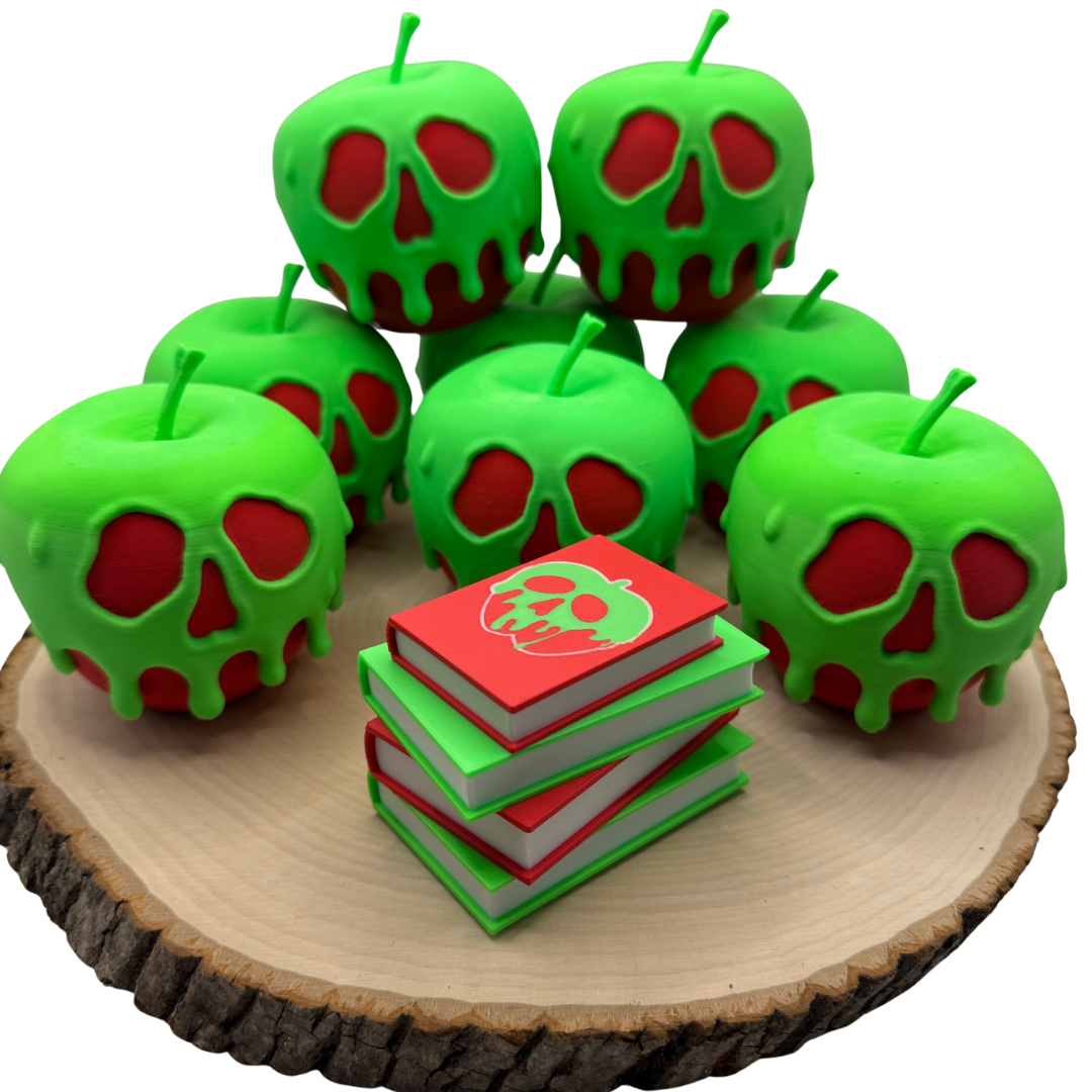 Poison apple light up stack of books with the light turned off sitting on a piece of wood surrounded by evil queen poison apples.