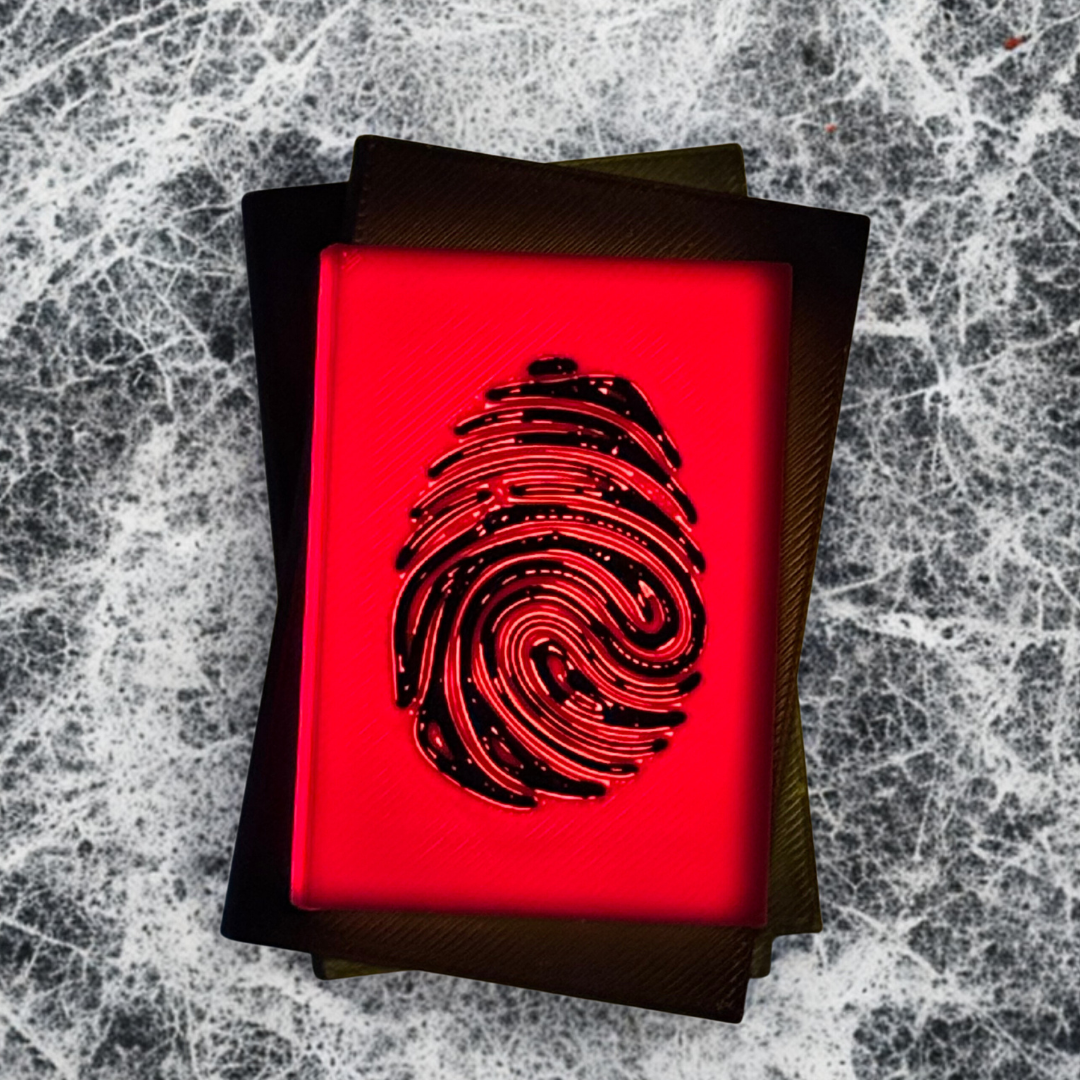 The top view of a true crime book light with the light turned on, with a white and silver background.