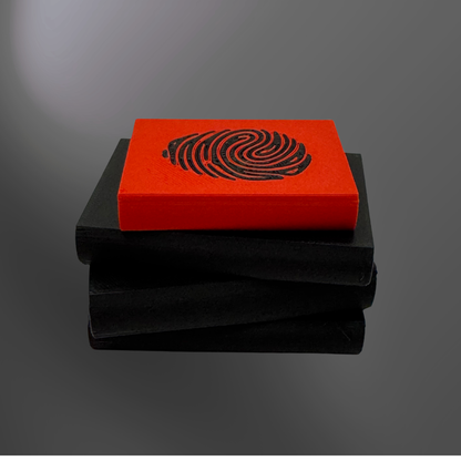 The back view of a true crime book light with the light turned off on a charcoal background.