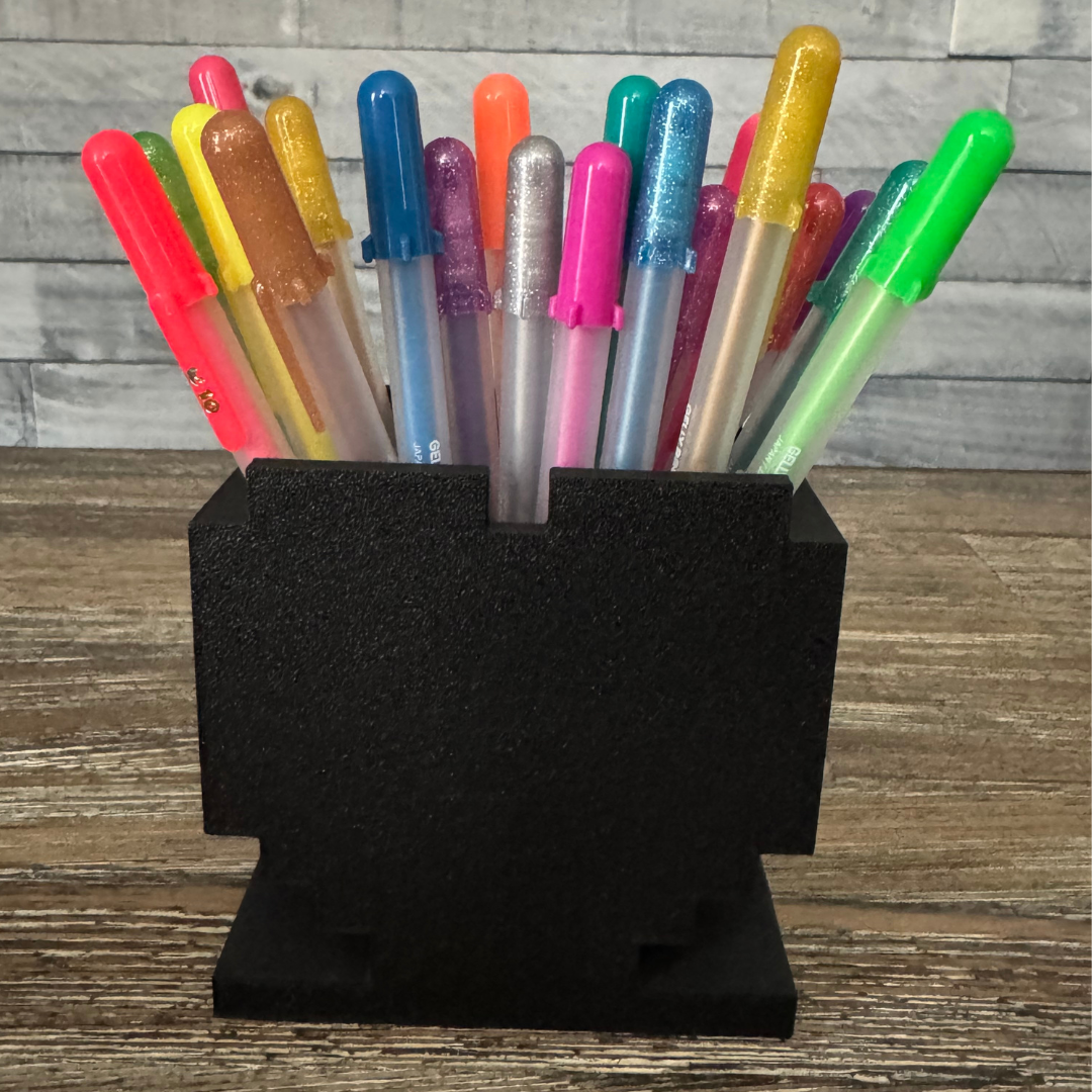 Back side of 8-Bit Pixel Heart Gaming Pen & Pencil Holder while sitting on a wooden table.