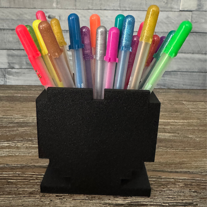Back side of 8-Bit Pixel Heart Gaming Pen & Pencil Holder while sitting on a wooden table.