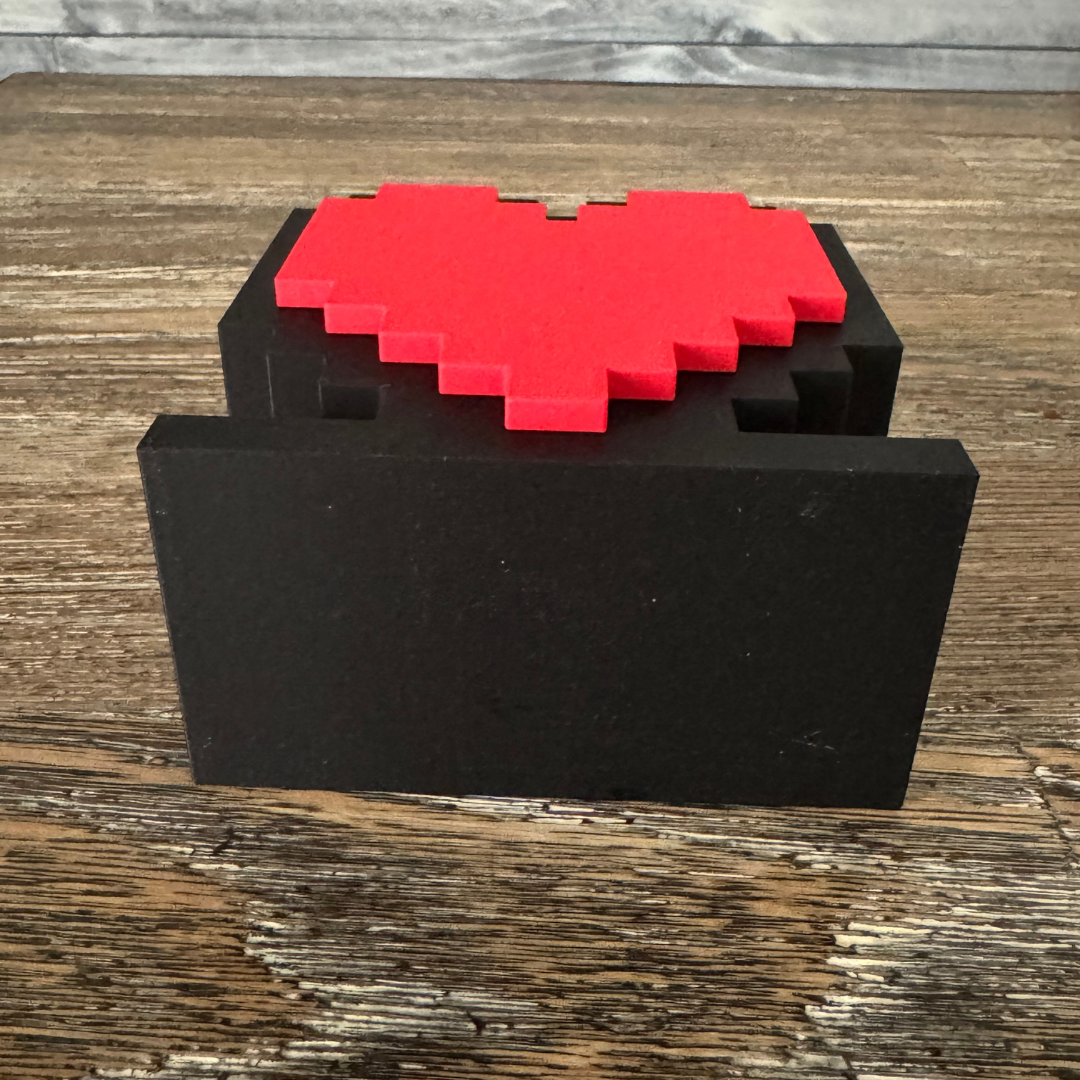 Bottom view of the 8-Bit Pixel Heart Gaming Pen & Pencil Holder while sitting on a wooden table.
