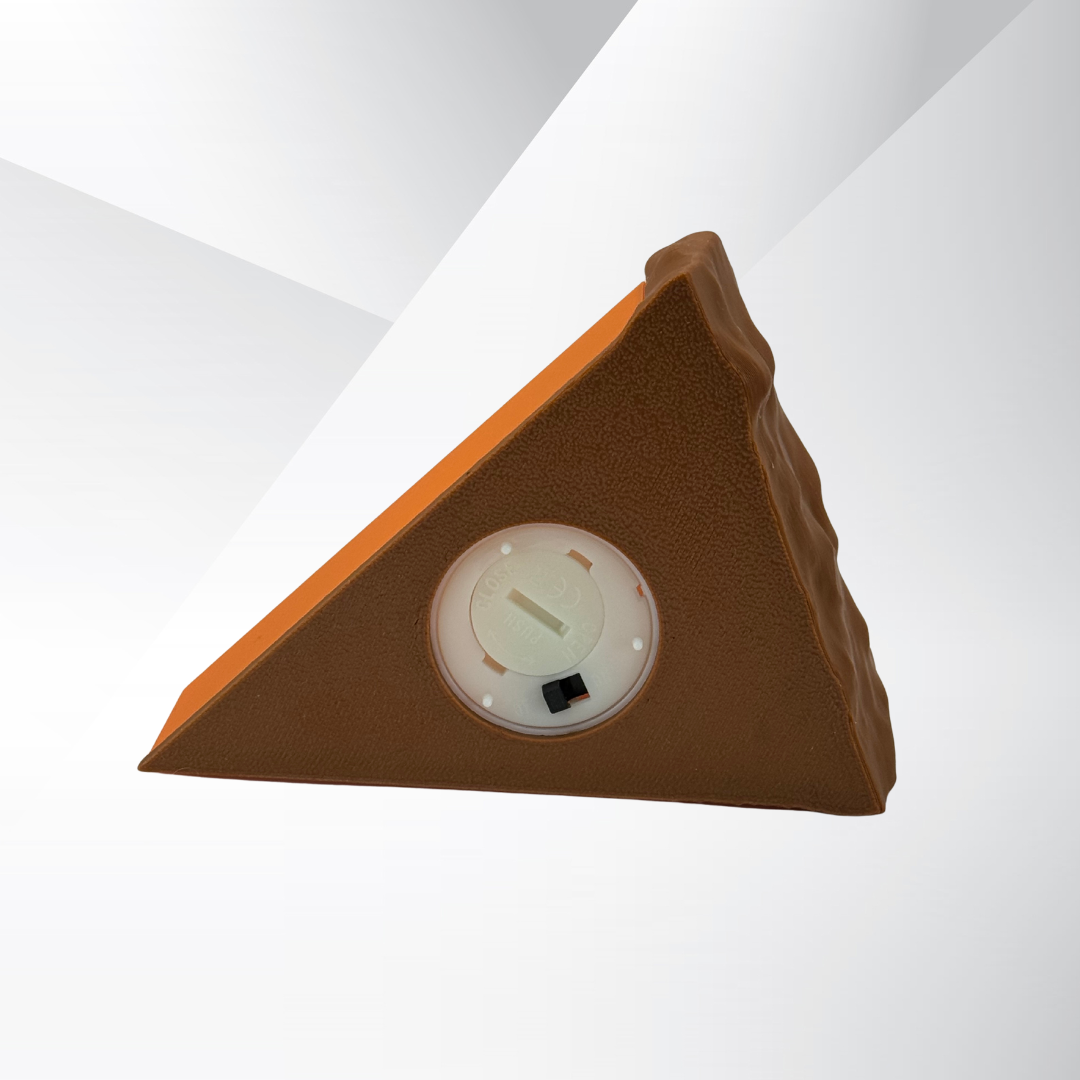 Bottom view of the light switch on the pumpkin pie light with a white and silver background.