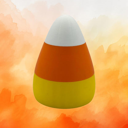 A glowing candy corn shaped light, casting a warm orange, yellow, and white glow, perfect as a Halloween or Thanksgiving decoration.