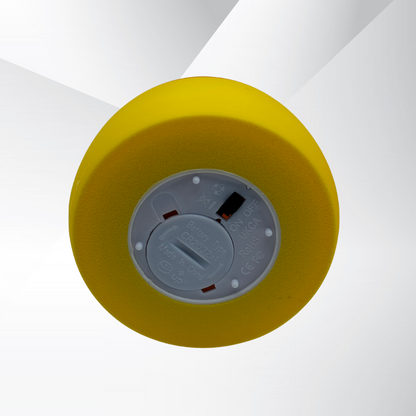 The view of the light switch at the bottom of the candy corn light with a silver and white background.
