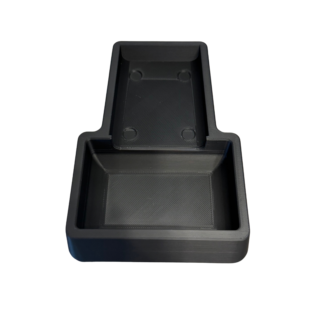 Inside of the Black coin tray with an Insert Coin Cube inside.