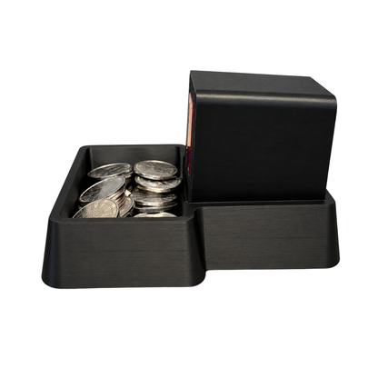 Left side of the Black coin tray with an Insert Coin Cube inside.