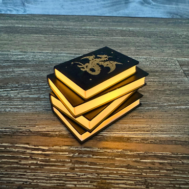 View of the Fantasy Dragon Book Light glowing while sitting on a wooden table.