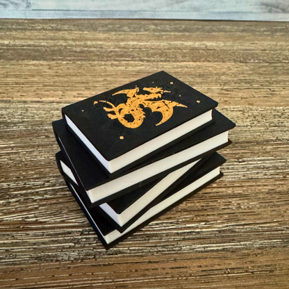 View of the Fantasy Dragon Book Light with the light turned off while sitting on a wooden table.