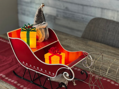 Illuminated Christmas gifts inside Santa's sleigh.