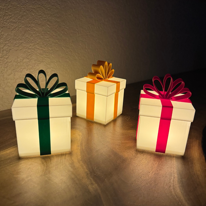 Three Christmas gift lights lit up on a live edge wooden shelf.