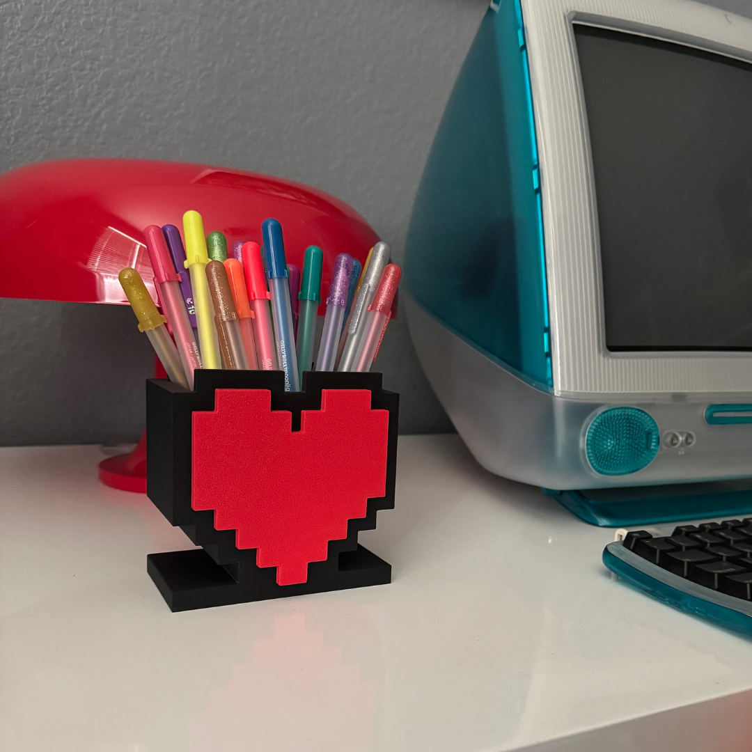 View of the 8-Bit Pixel Heart Gaming Pen & Pencil Holder while sitting on a white desk.
