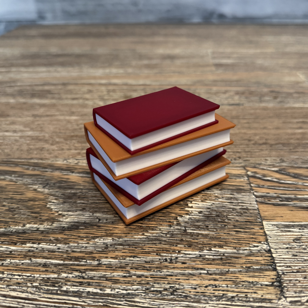 Cozy brown and maroon light up book stack sitting on a wooden table.