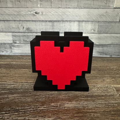 8-Bit Pixel Heart Gaming Pen & Pencil Holder empty sitting on a wooden table.