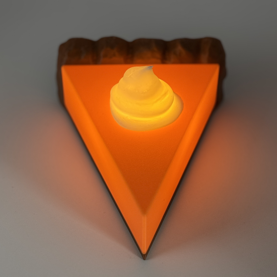 Pumpkin pie light lit up with a white background.