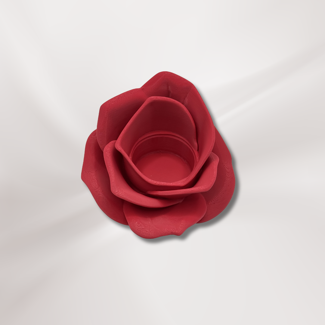 A 3d printed red rose tea light holder with the tea light removed on an off white background.