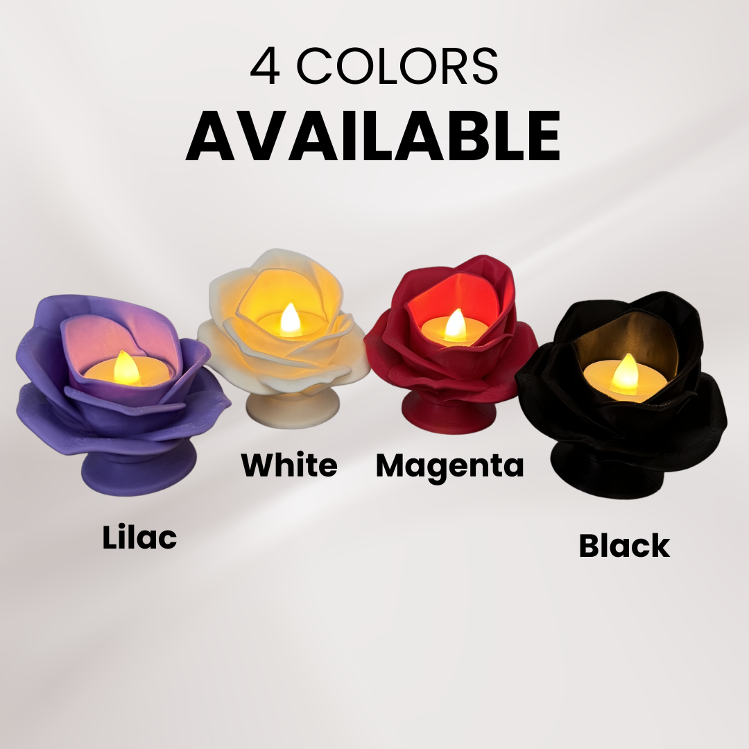 Four 3d printed rose tea light holders with a tea light turned on displaying all four color variations available on an off white background.