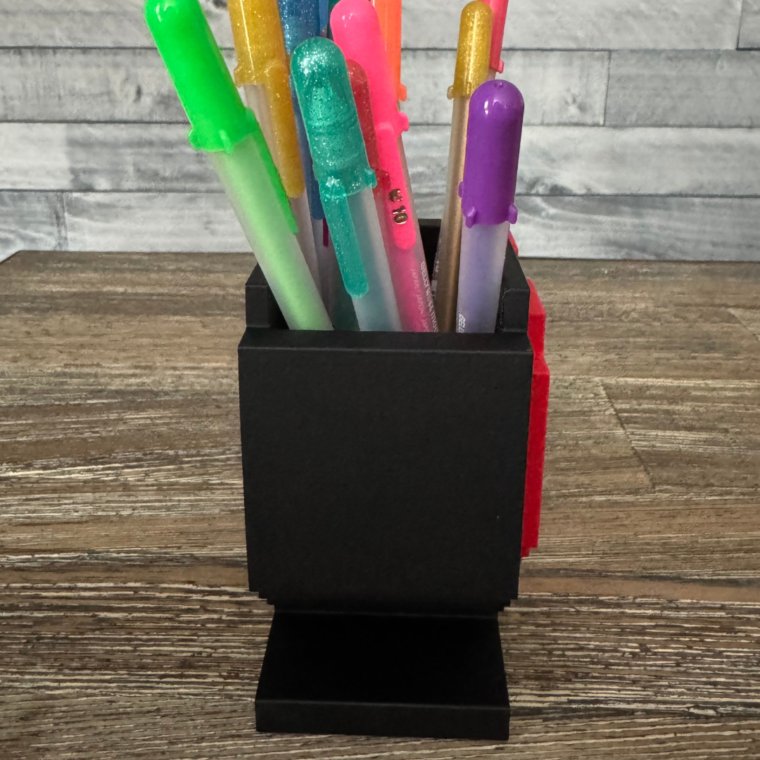 Side view of the 8-Bit Pixel Heart Gaming Pen & Pencil Holder while sitting on a wooden table.