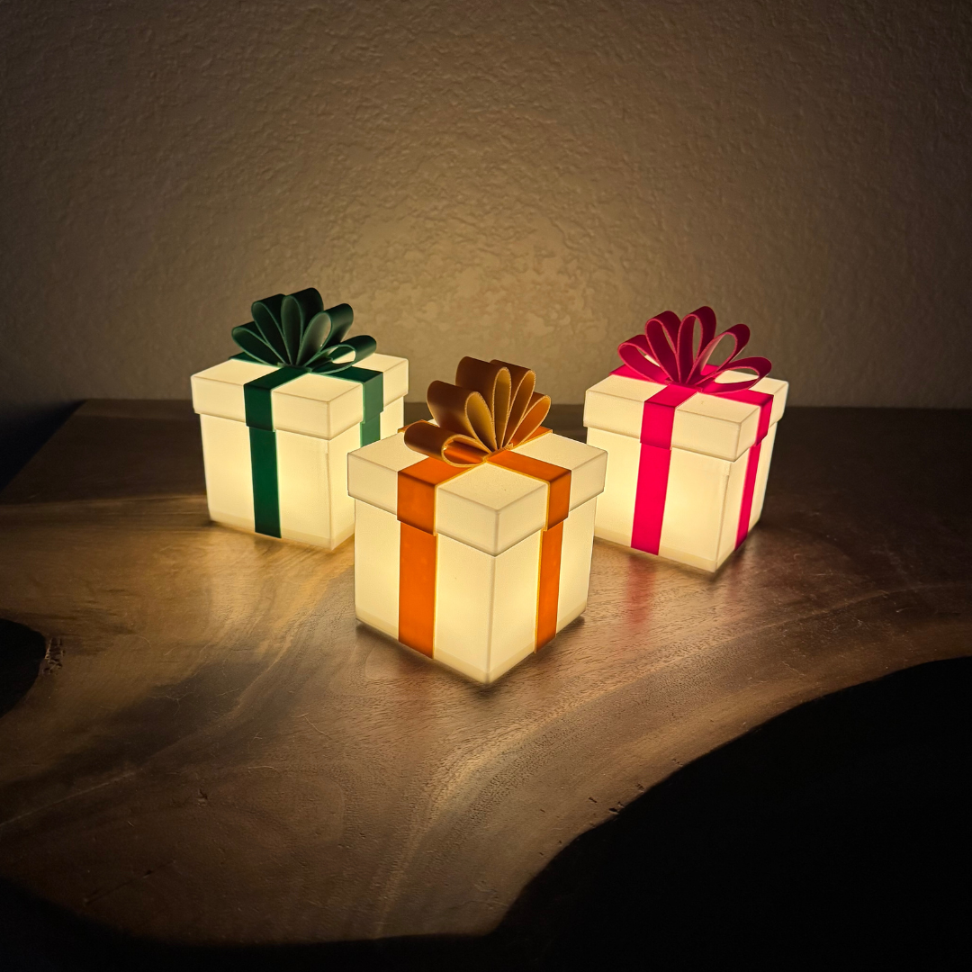 Three Christmas packages lit up sitting on a live edge wooden shelf.