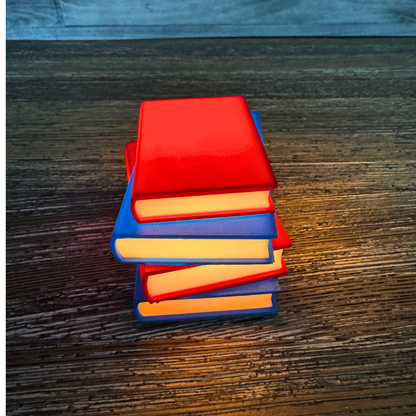 Vibrant red and blue light up stack of books sitting on a wooden shelf as bookish decor.