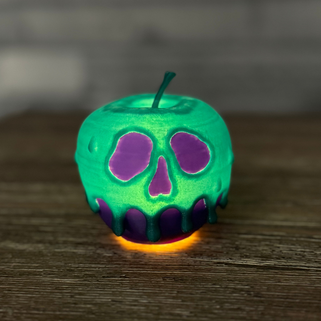 A glowing purple and teal poison candy apple on a wooden table casting an eerie light, ideal for Halloween decor.