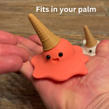 View of strawberry 3d printed melting ice cream cone made by Chronic Concepts being held in the palm of a hand to depict the size of the sculpture.