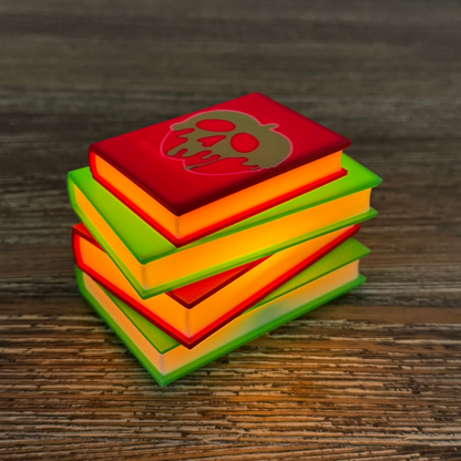 Poison apple light up stack of books sitting on a wooden shelf as bookish decor.