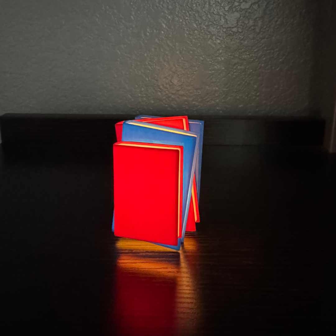 Vibrant red and blue light up stack of books standing up on a bookshelf.