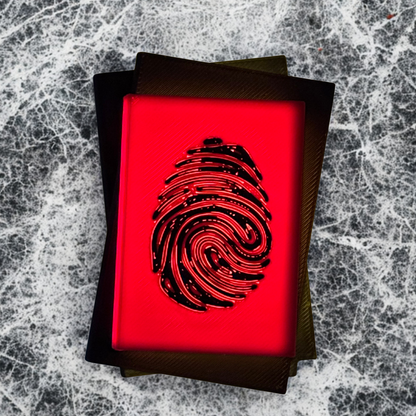The top view of a true crime book light with the light turned on, with a white and silver background.
